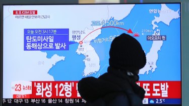 A man watches a TV screen showing a local news program reporting North Korea's missile launch at the Seoul Train Station in Seoul on Wednesday.