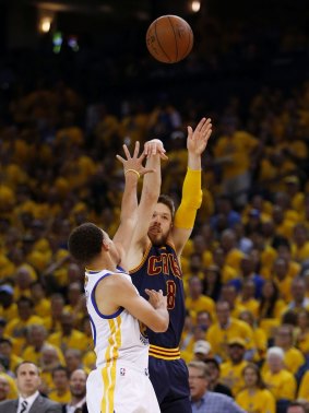 Taking his shot at the big time: Cavaliers guard Matthew Dellavedova shoots against Warriors rival Stephen Curry during game two of the NBA Finals at ORACLE Arena in Oakland, California. 
