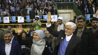 The head of the reformists' coalition list in Tehran, Mohammad Reza Aref, waves to the crowd next to his wife Hamideh at a campaign rally in the Iranian capital on Thursday.