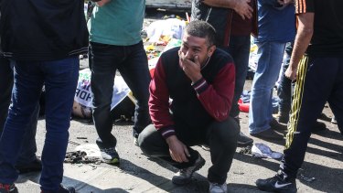 A man cries at the blast scene after an explosion during a peace march in Ankara.