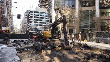 Diggers rip up roadway on the intersection of George, Bridge and Grosvenor streets in Sydney's CBD on Saturday.