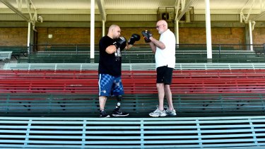 Home turf: Lewis puts Australian fighter Brad Hardman through his paces in the grandstand at Erskineville Oval.