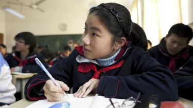 Students work in a classroom at a middle school affiliated with the Jing'An Teachers' College in Shanghai. 