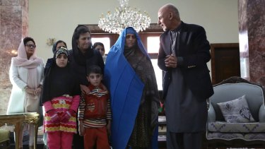 Afghan President Ashraf Ghani, right, welcomes National Geographic's famed green-eyed "Afghan Girl," Sharbat Gulla (in blue), and family, at the Presidential palace in Kabul, Afghanistan on Wednesday.