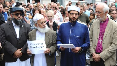 Members of the British Muslim Forum and religious leaders from Christian and Jewish faiths pay their respects at St Ann's square in Manchester on Sunday.