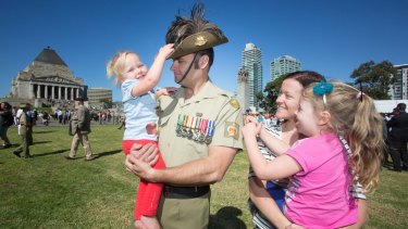 'A sense of belonging': Chris Sharp, who served as a sergeant, holds daughter Ruby, while his wife Jocelyn is pictured with Hayley.