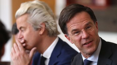 Dutch Prime Minister Mark Rutte sits next to Geert Wilders.