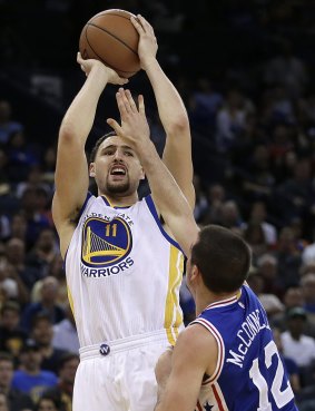 Shooting star: Golden State Warriors guard Klay Thompson nails a basket over Philadelphia 76ers opponent TJ McConnell in Oakland.