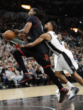 Houston Rockets centre Nene Hilario is fouled by San Antonio Spurs guard Patty Mills during game one of the western conference semi-final series. 