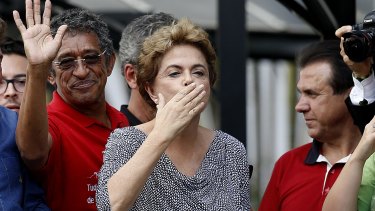 Brazilian President Dilma Rousseff blows a kiss to supporters after visiting former president Luiz Inacio Lula da Silva, at his residence in Sao Bernardo do Campo, after his brief detention for questioning.