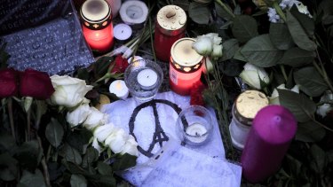 Candles and flowers at the gates of the French Embassy in Berlin on Sunday. 