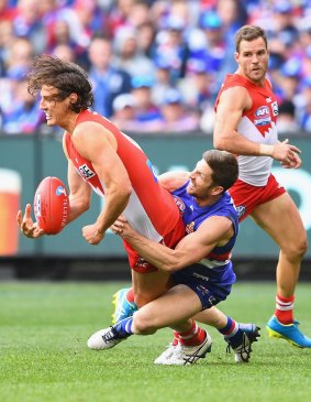 The indefatigable Dale Morris brings down Kurt Tippett in the grand final