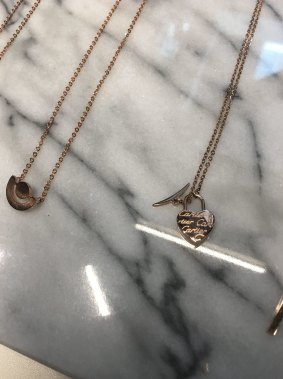 EM Style has been accused by Hermes of selling copies of some of its trademarked designs. Pictured is a necklace bearing the "Cartier" signature.