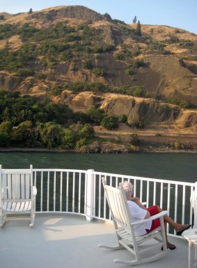 Admiring views of the Columbia River near The Dalles from the deck of American Queen Steamboat Company's American Empress. 