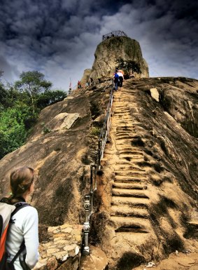 Tourists climbing to Summit Hill, Aradhana Gala, at Mihintale near ancient capitol Ambasthalaya of Sri Lanka.   