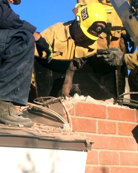 Emergency personnel dismantled the chimney brick-by-brick.