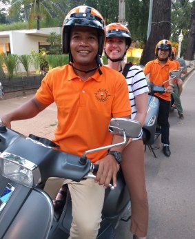 Vespa drivers and passengers on a food tour in Siem Reap.