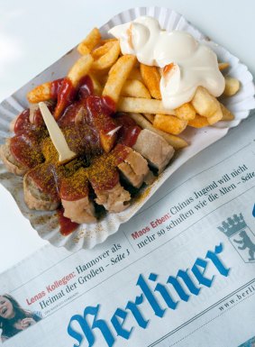 Traditional Berlin currywurst snack at famous Konnopke`s currywurst stall in Prenzlauer Berg.
