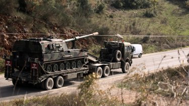 A Turkish army truck loaded with self-propelled guns heads to the Syrian border.