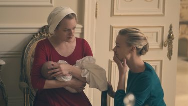 Offred the handmaid, played by Elizabeth Moss, and commander's wife Serena Joy, played by Yvonne Strahovski. 