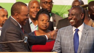 Uhuru Kenyatta, left, congratulates his deputy William Ruto, right, after they were announced the winners in the re-run of presidential election.