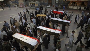 Mourners in the Iraqi city of Najaf carry the coffins of five Shiite militiamen killed on the outskirts of Tikrit during fighting with IS militants.