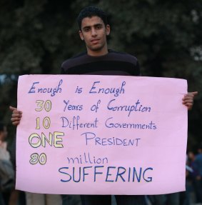 A man holds a placard in Cairo's Tahrir Square in January 2011.