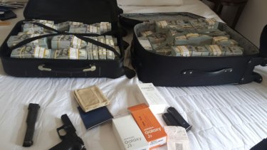 Suitcases of money and other items seized by Brazilian police during the arrest of drug lord Luiz Carlos da Rochaon Saturday.