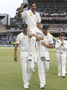 Johnson is chaired off the ground by fellow fast bowlers Mitch Starc and Josh Hazlewood.