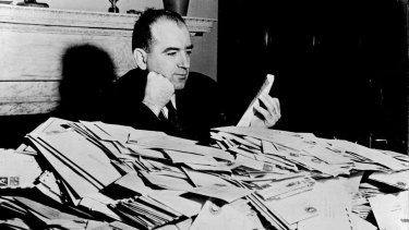 Senator Joseph McCarthy with the avalanche of mail that greeted his crusade against communism in the US government and public life, December 1952.  