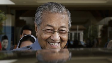 Mahathir Mohamad smiles after announcing he had quit the ruling UMNO party, saying it had been hijacked by his embattled successor, Najib Razak, to protect his interests.