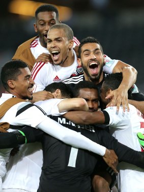 Members of the United Arab Emirates team celebrate after they qualified for the Asian Cup semi-finals.