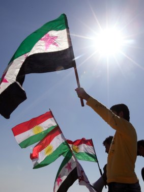 Syrian Kurds living in Lebanon hold the pre-Baathist flag of the Syrian rebellion alongside Kurdish nationalist flags. 
