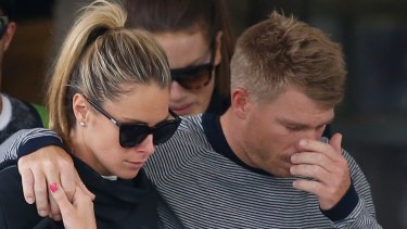 David Warner, accompanied by his wife Candice Falzon cries as he leaves the hospital on Thursday. 