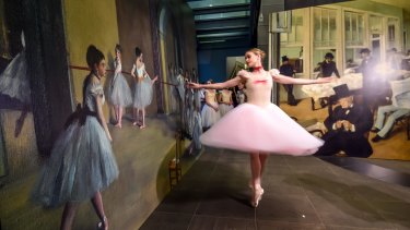 The Australian Ballet's Sarah Thompson dances in front of a print of Degas' <i>Rehearsal hall at the Opera, rue Le Peletier</i>, 1872, at the National Gallery of Victoria.