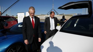 Minister for Urban Infrastructure Paul Fletcher and Minister for Environment and Energy Josh Frydenberg during an electric car event on the front lawn of Parliament House in Canberra.
