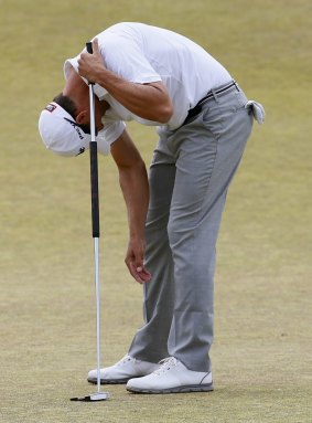 Australian Adam Scott reacts to his putt on the fifth hole during the first round.