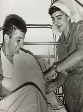 Terrie Ross secures a sling on an Australian soldier at the 8th Field Ambulance, Vung Tau.