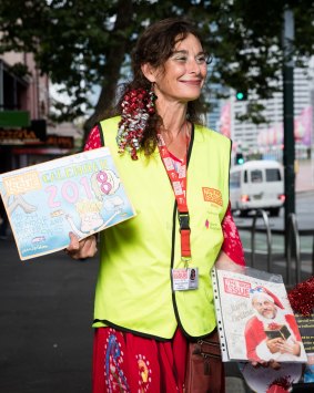 Rachel T sells the Big Issue calendar while wishing passersby a Merry Christmas.