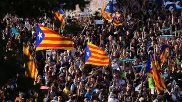 Thousands of protesters wave Catalonia independence flags as they take part in a rally against the National Court's decision to imprison civil society leaders.