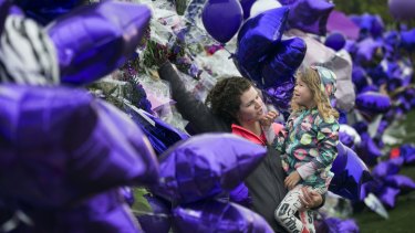 Joy Meuleners holds her niece Keira Abeln at a memorial for Prince at Paisley Park on Sunday in Minneapolis.