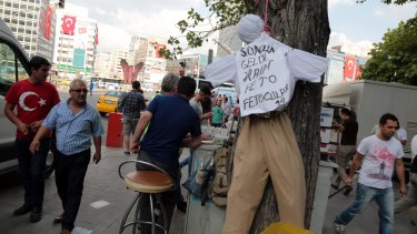 People pass by an effigy of Fethullah Gulen with a sign that reads "The traitor, FETO"  - a reference to the alleged terrorist organisation which the Turkish government blames for July's attempted coup.