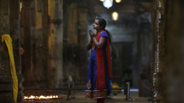 An ethnic Tamil woman prays at a Hindu temple in Colombo, Sri Lanka, on Friday.