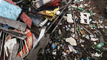 Garbage rests on the shoreline of Guanabara Bay.