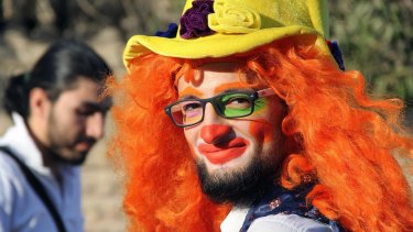 Syrian social worker Anas al-Basha, 24, dressed as a clown, while posing for a photograph in Aleppo, Syria. 