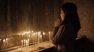A Damascus woman prays in St Sarkis.