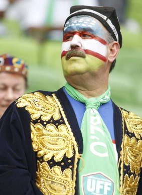 An Uzbek fan makes no secret of where loyalties lie as he awaits the start of the quarter-final against Sourh Korea.