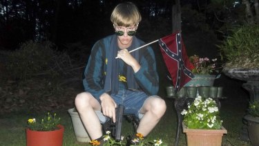 Dylann Roof, charged with carrying out the Charleston church massacre, poses with a Confederate flag and a Glock pistol in  this photo with a digital timestamp of April 27, 2015. 