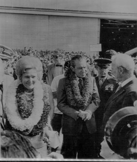 President Richard M. Nixon and wife Pat with leis around their necks chat with Hawaii Governor John A. Burns (R) on their arrival here 2/17 en route to China. 