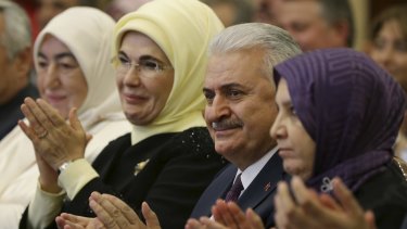 Binali Yildirim, centre,Turkey's Transport Minister, sitting next to Emine Erdogan, second left, the wife of Turkish President Recep Tayyip Erdogan.